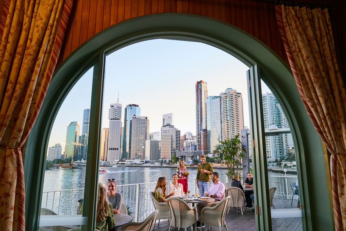 An image of people alfresco dining from indoor view with arch door
