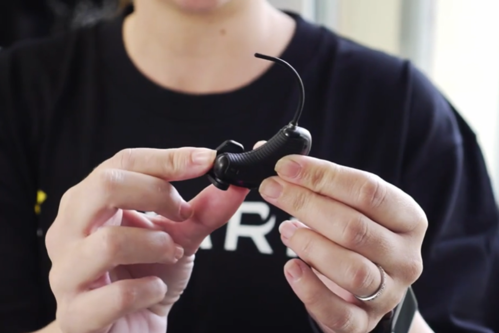 Hands holding ear technology